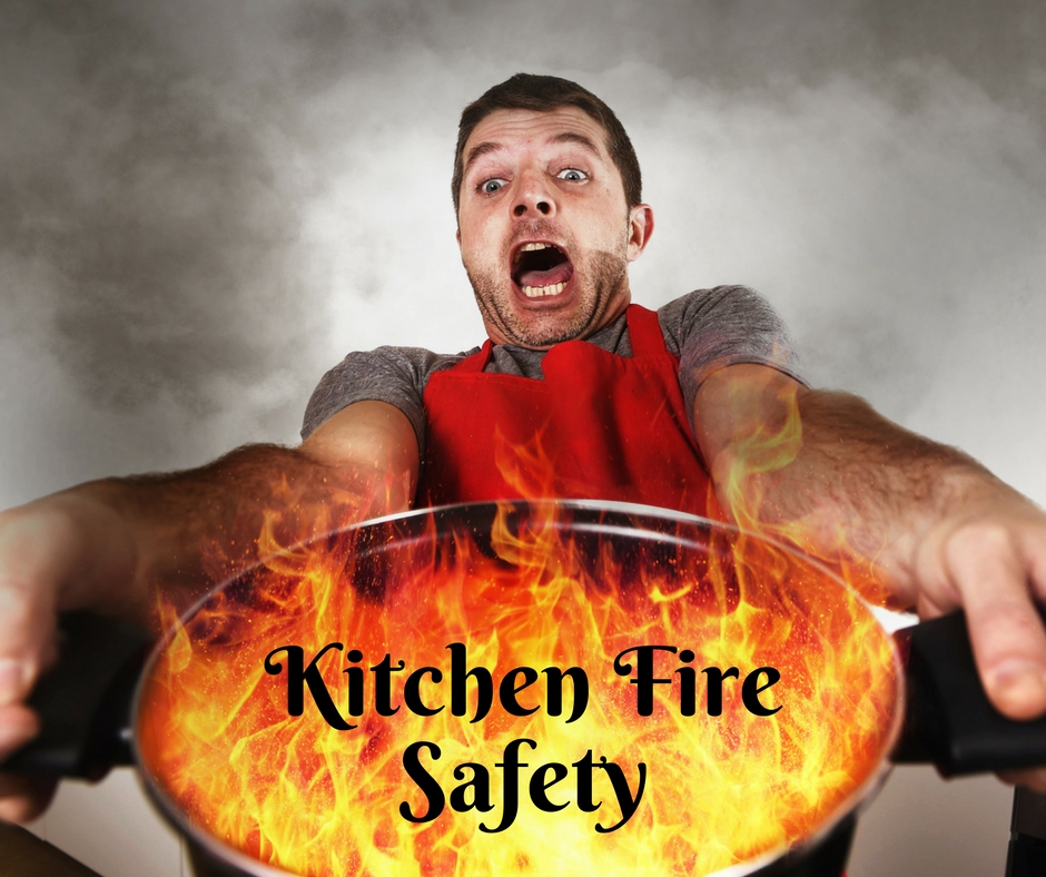 Man holding a flaming pan with text "kitchen fire safety"