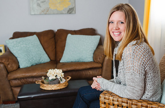 Woman sits in living room