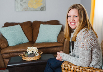 Woman sits in living room