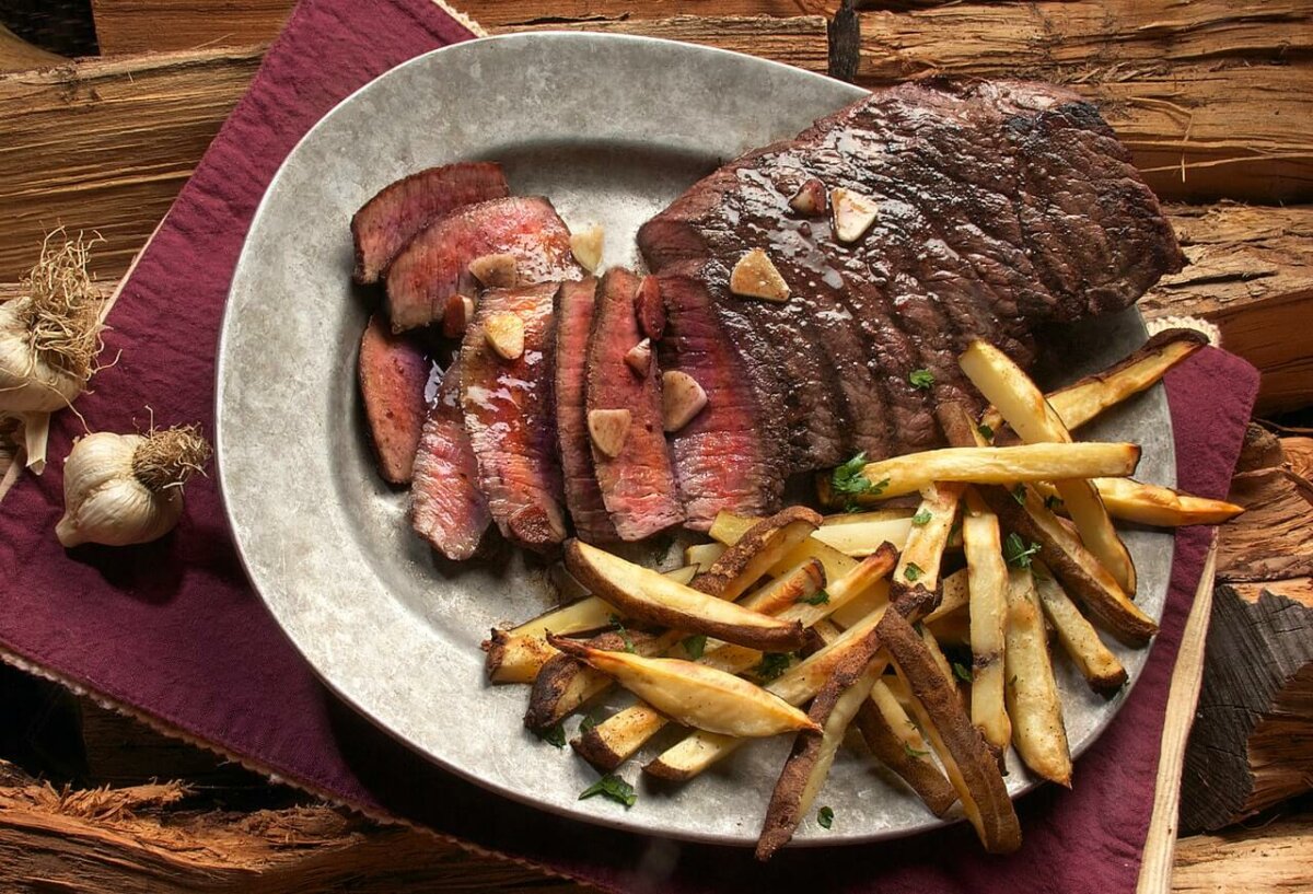 Photo of steak and french fries on a platter. Photo credit: Kasumi Loffler