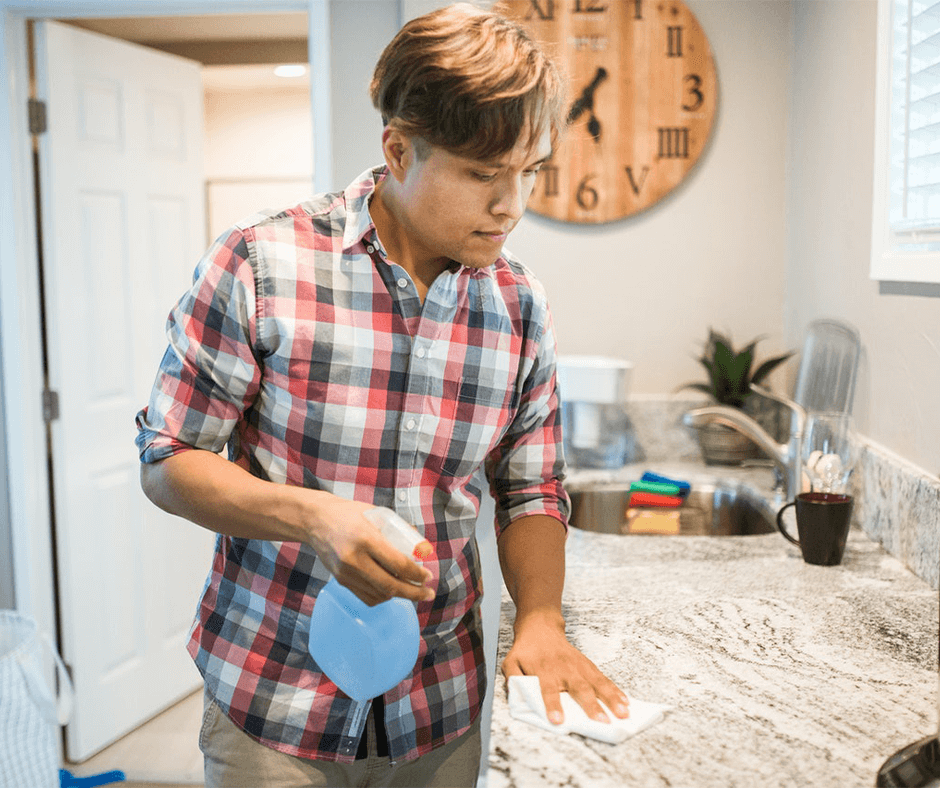Man wiping a kitchen counter. Image: RODNAE Productions