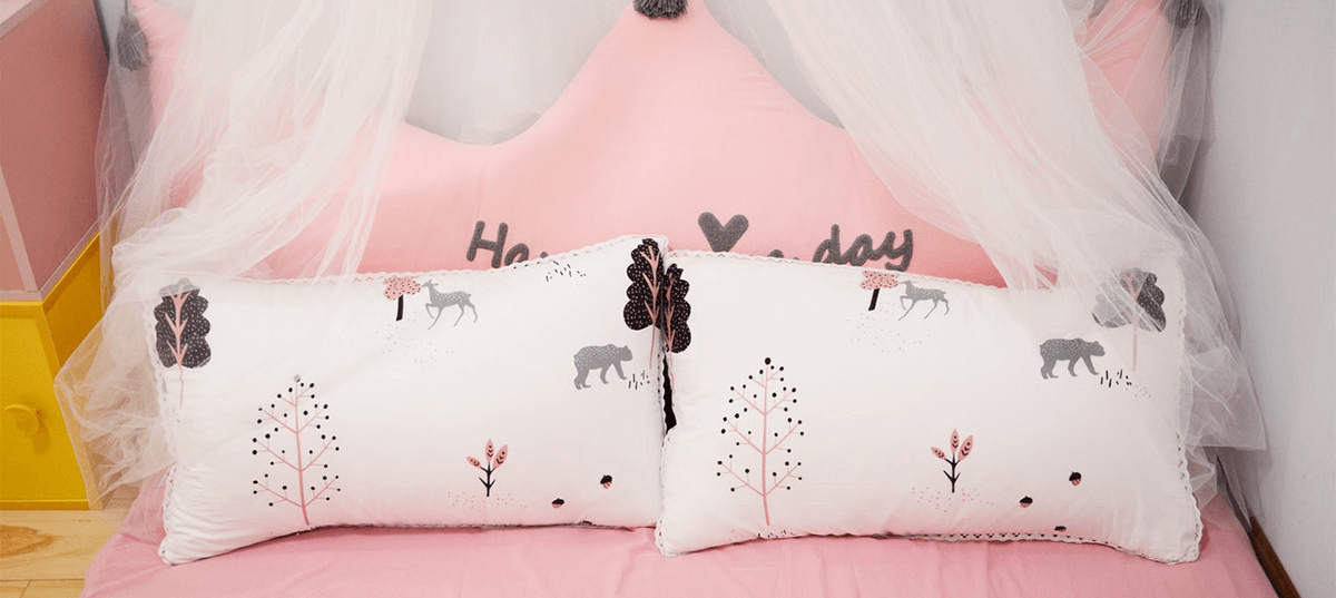 Bed with a pink duvet. Image credit: Cat Common