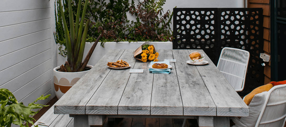 Small outdoor patio decorated in cottage style. Image credit: Rachel Claire