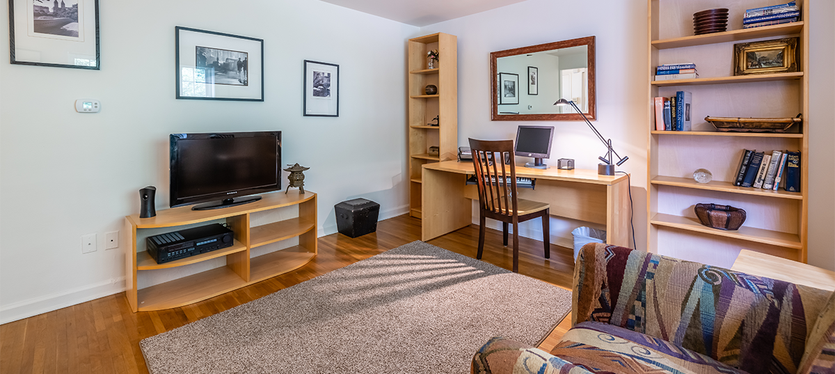 Living room of a one-bedroom apartment at Elmwood Manor